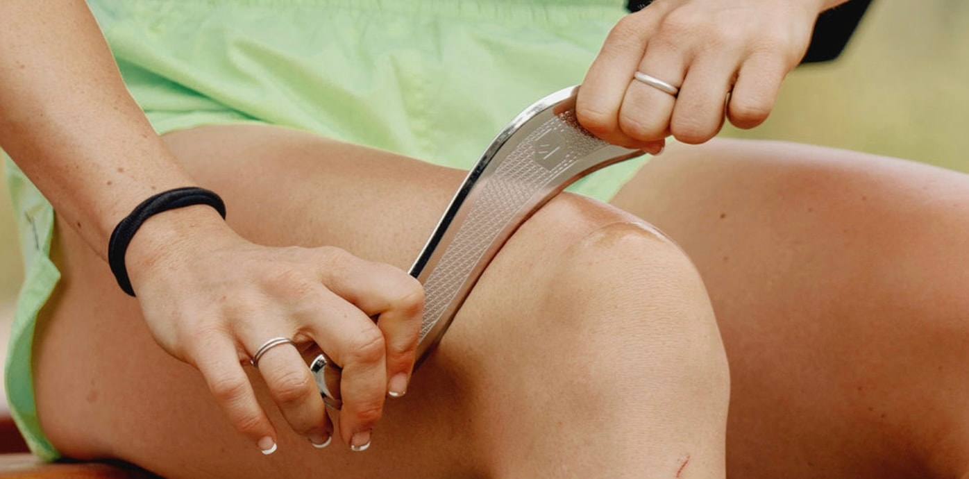 A person is stretching their leg in a home gym, focusing on muscle recovery after a workout. This action helps relieve soreness and improve blood flow, promoting healing and flexibility in the lower leg muscles.