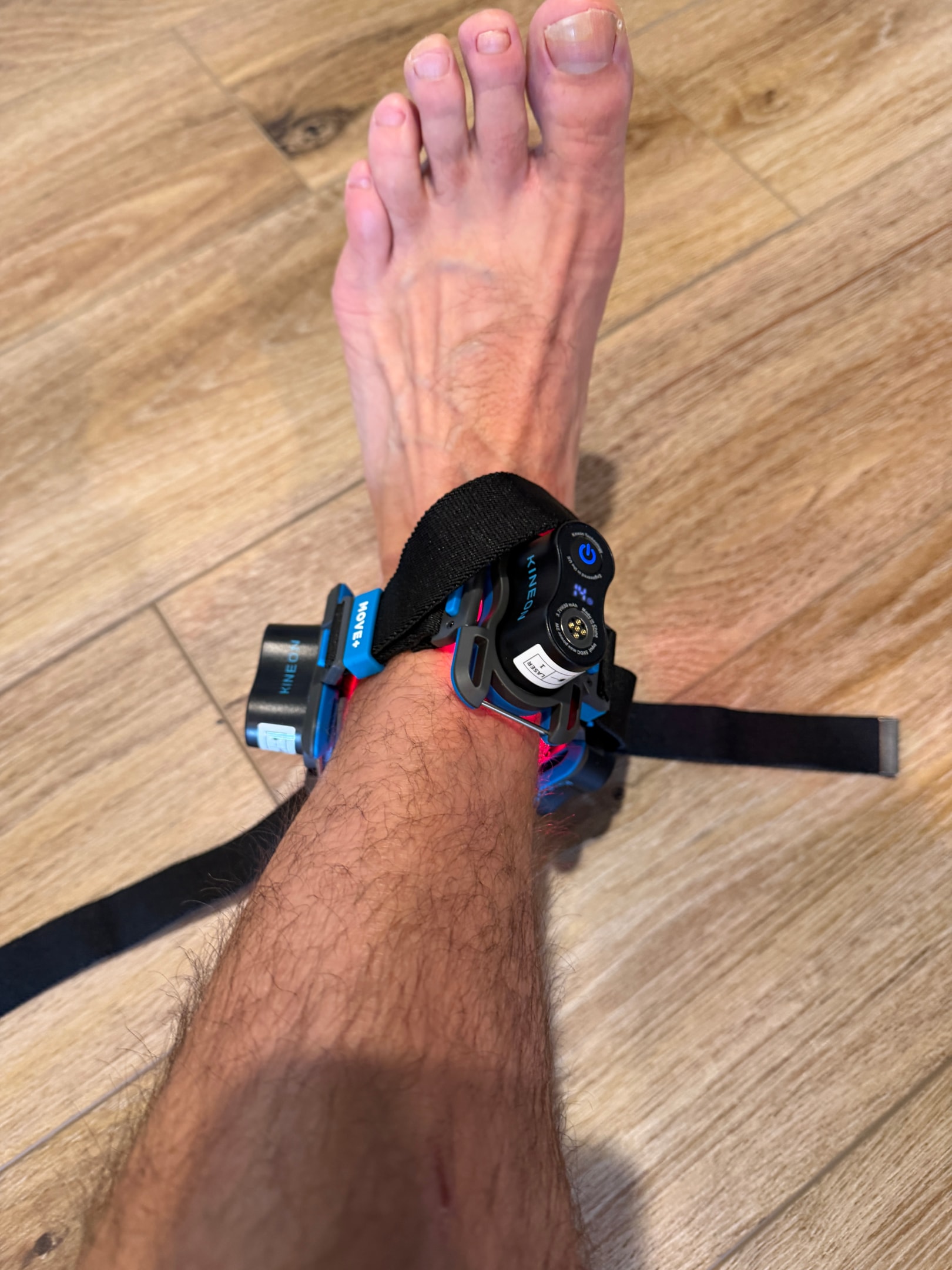 A runner is outdoors stretching their leg after a training session, focusing on recovery and pain management. This scene highlights the importance of physical therapy and techniques like red light therapy for relieving joint pain and improving blood flow, essential for athletes dealing with muscle fatigue and chronic conditions.